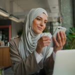 Muslim woman on remote working, online education or video conversation in caffe